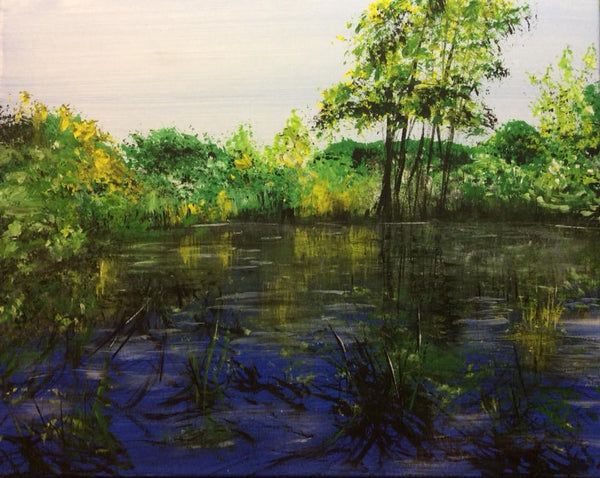 A little pond in front of the bridge below the side of the road