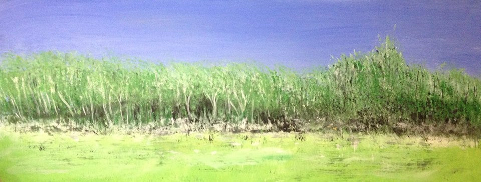 Endowed by spring is a field and trees against a blue sky green